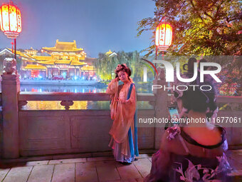 Tourists dressed in Hanfu visit the ancient city of Luoyi in Luoyang, Henan province, China, on October 16, 2024. (