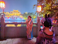 Tourists dressed in Hanfu visit the ancient city of Luoyi in Luoyang, Henan province, China, on October 16, 2024. (