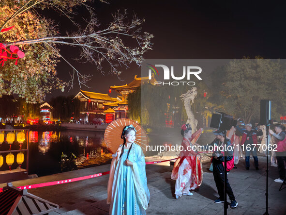 Tourists dressed in Hanfu visit the ancient city of Luoyi in Luoyang, Henan province, China, on October 16, 2024. 