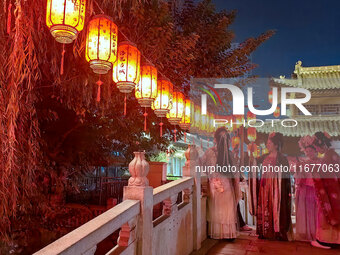 Tourists dressed in Hanfu visit the ancient city of Luoyi in Luoyang, Henan province, China, on October 16, 2024. (