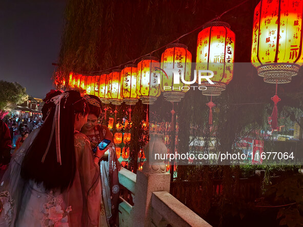 Tourists dressed in Hanfu visit the ancient city of Luoyi in Luoyang, Henan province, China, on October 16, 2024. 