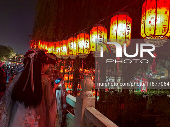 Tourists dressed in Hanfu visit the ancient city of Luoyi in Luoyang, Henan province, China, on October 16, 2024. (