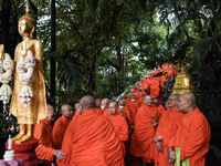 Thai Buddhist monks prepare for a morning alms ritual to mark the end of the Buddhist Lent, known as 'Awk Phansa day', at Golden Mount templ...