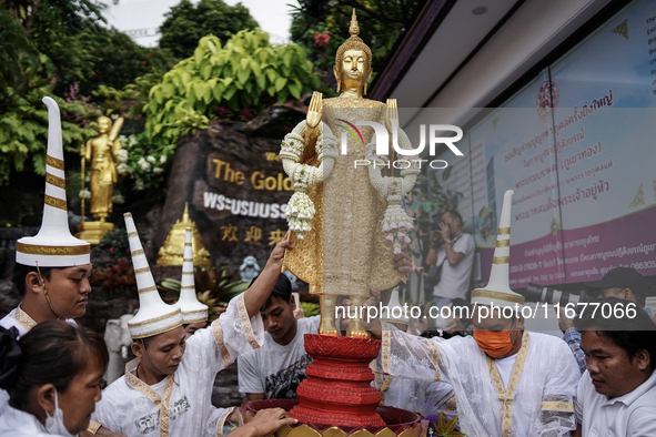 Thai Buddhist devotees dress as Thai angels and carry a statue of Lord Buddha to mark the end of the Buddhist Lent, known as 'Awk Phansa day...