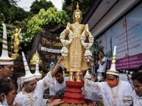 Thai Buddhist devotees dress as Thai angels and carry a statue of Lord Buddha to mark the end of the Buddhist Lent, known as 'Awk Phansa day...