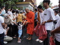 Buddhist devotees attend a morning alms ritual to mark the end of the Buddhist Lent, known as 'Awk Phansa day', at Golden Mount temple in Ba...