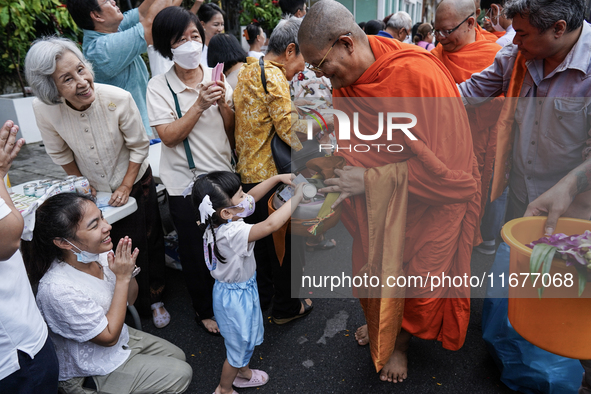 Buddhist devotees attend a morning alms ritual to mark the end of the Buddhist Lent, known as 'Awk Phansa day', at Golden Mount temple in Ba...