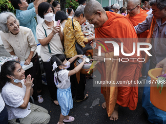 Buddhist devotees attend a morning alms ritual to mark the end of the Buddhist Lent, known as 'Awk Phansa day', at Golden Mount temple in Ba...