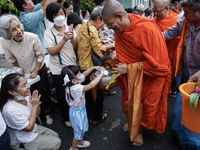 Buddhist devotees attend a morning alms ritual to mark the end of the Buddhist Lent, known as 'Awk Phansa day', at Golden Mount temple in Ba...