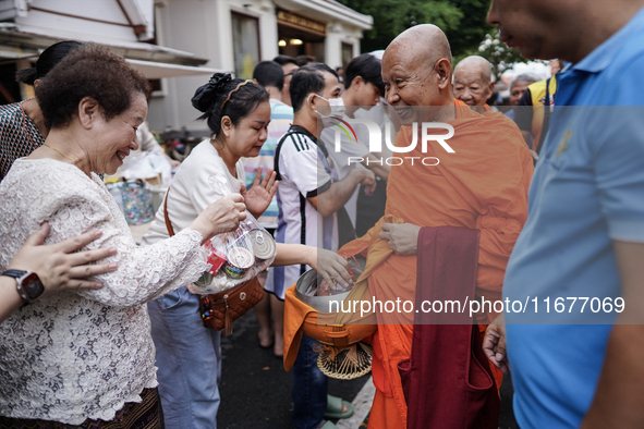 Buddhist devotees attend a morning alms ritual to mark the end of the Buddhist Lent, known as 'Awk Phansa day', at Golden Mount temple in Ba...