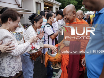 Buddhist devotees attend a morning alms ritual to mark the end of the Buddhist Lent, known as 'Awk Phansa day', at Golden Mount temple in Ba...