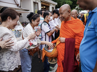 Buddhist devotees attend a morning alms ritual to mark the end of the Buddhist Lent, known as 'Awk Phansa day', at Golden Mount temple in Ba...