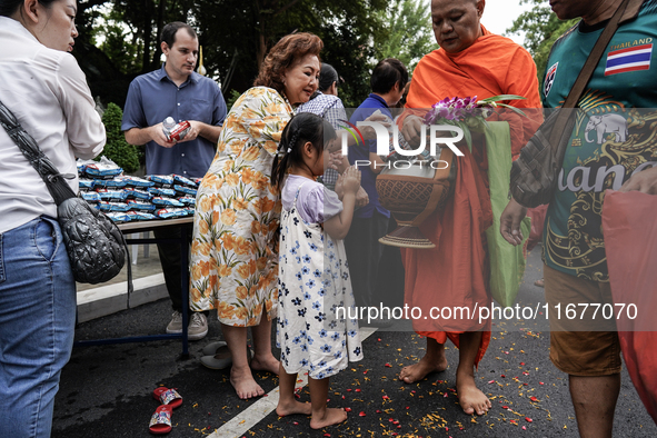 Buddhist devotees attend a morning alms ritual to mark the end of the Buddhist Lent, known as 'Awk Phansa day', at Golden Mount temple in Ba...