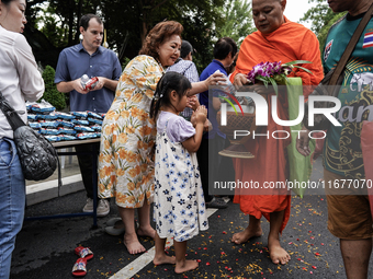 Buddhist devotees attend a morning alms ritual to mark the end of the Buddhist Lent, known as 'Awk Phansa day', at Golden Mount temple in Ba...