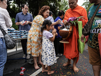 Buddhist devotees attend a morning alms ritual to mark the end of the Buddhist Lent, known as 'Awk Phansa day', at Golden Mount temple in Ba...