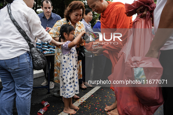 Buddhist devotees attend a morning alms ritual to mark the end of the Buddhist Lent, known as 'Awk Phansa day', at Golden Mount temple in Ba...