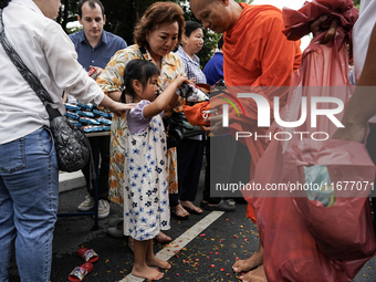 Buddhist devotees attend a morning alms ritual to mark the end of the Buddhist Lent, known as 'Awk Phansa day', at Golden Mount temple in Ba...