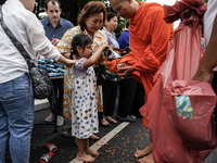 Buddhist devotees attend a morning alms ritual to mark the end of the Buddhist Lent, known as 'Awk Phansa day', at Golden Mount temple in Ba...