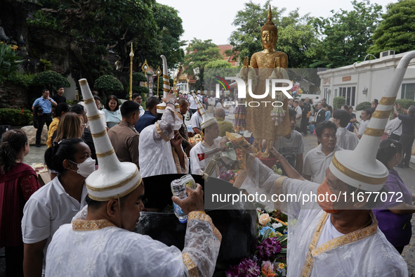 Buddhist devotees attend a morning alms ritual to mark the end of the Buddhist Lent, known as 'Awk Phansa day', at Golden Mount temple in Ba...