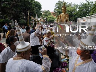 Buddhist devotees attend a morning alms ritual to mark the end of the Buddhist Lent, known as 'Awk Phansa day', at Golden Mount temple in Ba...