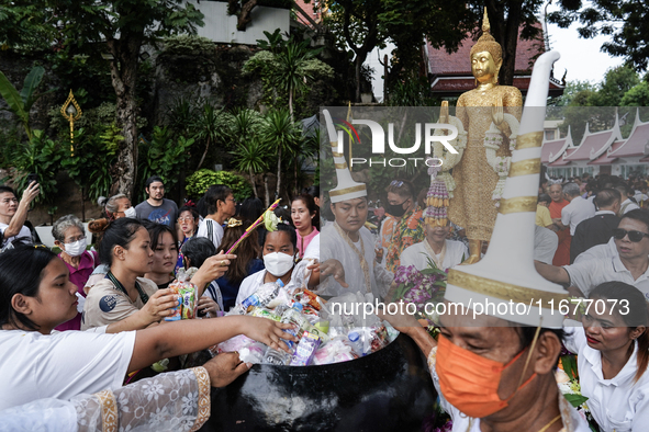 Buddhist devotees attend a morning alms ritual to mark the end of the Buddhist Lent, known as 'Awk Phansa day', at Golden Mount temple in Ba...