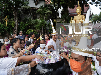 Buddhist devotees attend a morning alms ritual to mark the end of the Buddhist Lent, known as 'Awk Phansa day', at Golden Mount temple in Ba...