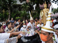 Buddhist devotees attend a morning alms ritual to mark the end of the Buddhist Lent, known as 'Awk Phansa day', at Golden Mount temple in Ba...