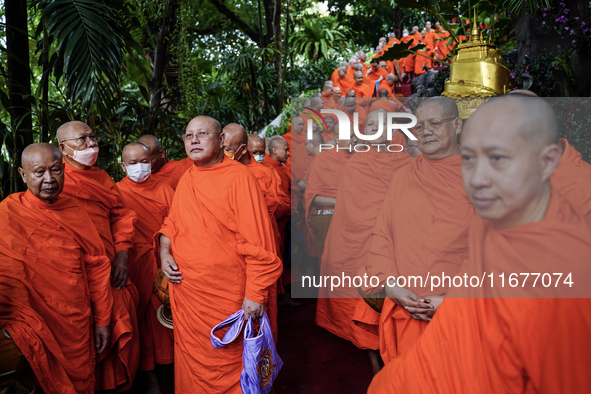 Thai Buddhist monks prepare for a morning alms ritual to mark the end of the Buddhist Lent, known as 'Awk Phansa day', at Golden Mount templ...