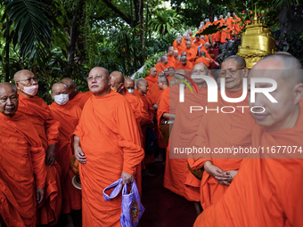 Thai Buddhist monks prepare for a morning alms ritual to mark the end of the Buddhist Lent, known as 'Awk Phansa day', at Golden Mount templ...