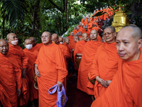 Thai Buddhist monks prepare for a morning alms ritual to mark the end of the Buddhist Lent, known as 'Awk Phansa day', at Golden Mount templ...