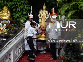 Thai Buddhist devotees dress as Thai angels and carry a statue of Lord Buddha to mark the end of the Buddhist Lent, known as 'Awk Phansa day...