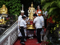 Thai Buddhist devotees dress as Thai angels and carry a statue of Lord Buddha to mark the end of the Buddhist Lent, known as 'Awk Phansa day...