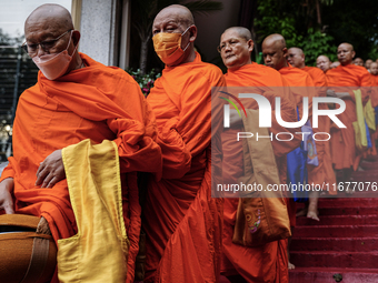 Thai Buddhist monks prepare for a morning alms ritual to mark the end of the Buddhist Lent, known as 'Awk Phansa day', at Golden Mount templ...