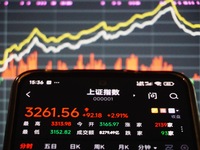 In Hangzhou, China, on October 18, 2024, a stockholder's mobile phone shows China's Shanghai Composite Index rising. (