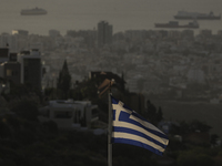 A Greek flag is seen on a mountainside overlooking the city. Limassol. Cyprus, Friday, October 18, 2024. The Cyprus issue is a European prob...