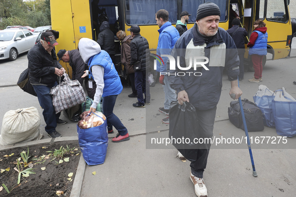 People from the Kupiansk community arrive at an evacuation point as mandatory evacuation from four communities in the Kharkiv region begins...