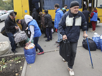 People from the Kupiansk community arrive at an evacuation point as mandatory evacuation from four communities in the Kharkiv region begins...