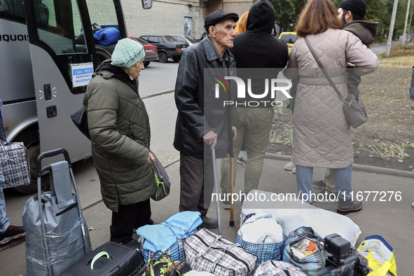 People from the Kupiansk community arrive at an evacuation point as mandatory evacuation from four communities in the Kharkiv region kicks o...