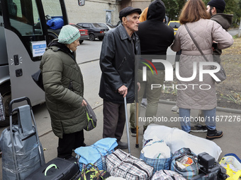 People from the Kupiansk community arrive at an evacuation point as mandatory evacuation from four communities in the Kharkiv region kicks o...