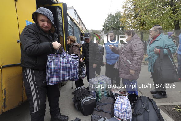 People from the Kupiansk community arrive at an evacuation point as mandatory evacuation from four communities in the Kharkiv region kicks o...