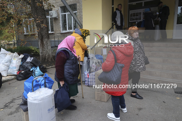 People from the Kupiansk community arrive at an evacuation point as mandatory evacuation from four communities in the Kharkiv region kicks o...