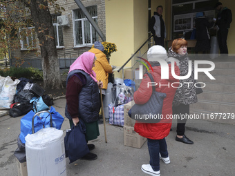 People from the Kupiansk community arrive at an evacuation point as mandatory evacuation from four communities in the Kharkiv region kicks o...