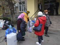 People from the Kupiansk community arrive at an evacuation point as mandatory evacuation from four communities in the Kharkiv region kicks o...