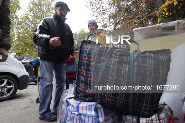 An elderly woman with crutches gets out of a bus at an evacuation point during the arrival of people from the Kupiansk community in Kharkiv,...