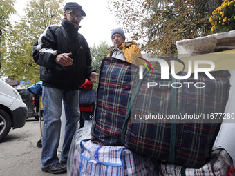 An elderly woman with crutches gets out of a bus at an evacuation point during the arrival of people from the Kupiansk community in Kharkiv,...