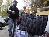 An elderly woman with crutches gets out of a bus at an evacuation point during the arrival of people from the Kupiansk community in Kharkiv,...