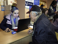 An elderly man receives help at an evacuation point during the arrival of people from the Kupiansk community in Kharkiv, Ukraine, on October...