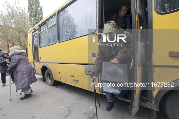 People from the Kupiansk community arrive at an evacuation point as mandatory evacuation from four communities in the Kharkiv region begins...