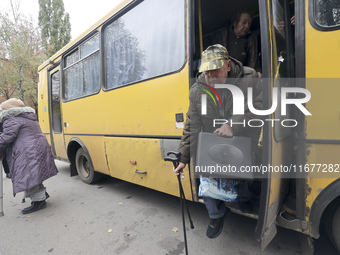 People from the Kupiansk community arrive at an evacuation point as mandatory evacuation from four communities in the Kharkiv region begins...