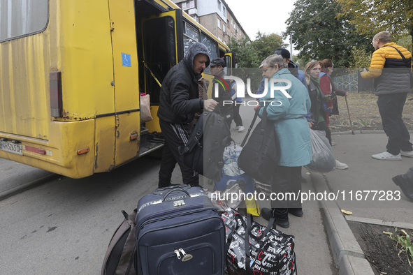 People from the Kupiansk community arrive at an evacuation point as mandatory evacuation from four communities in the Kharkiv region begins...